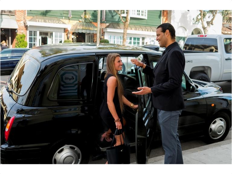 Driver opening door for passenger at The Saloon